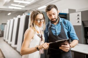 Woman with print operator at the printing manufacturing